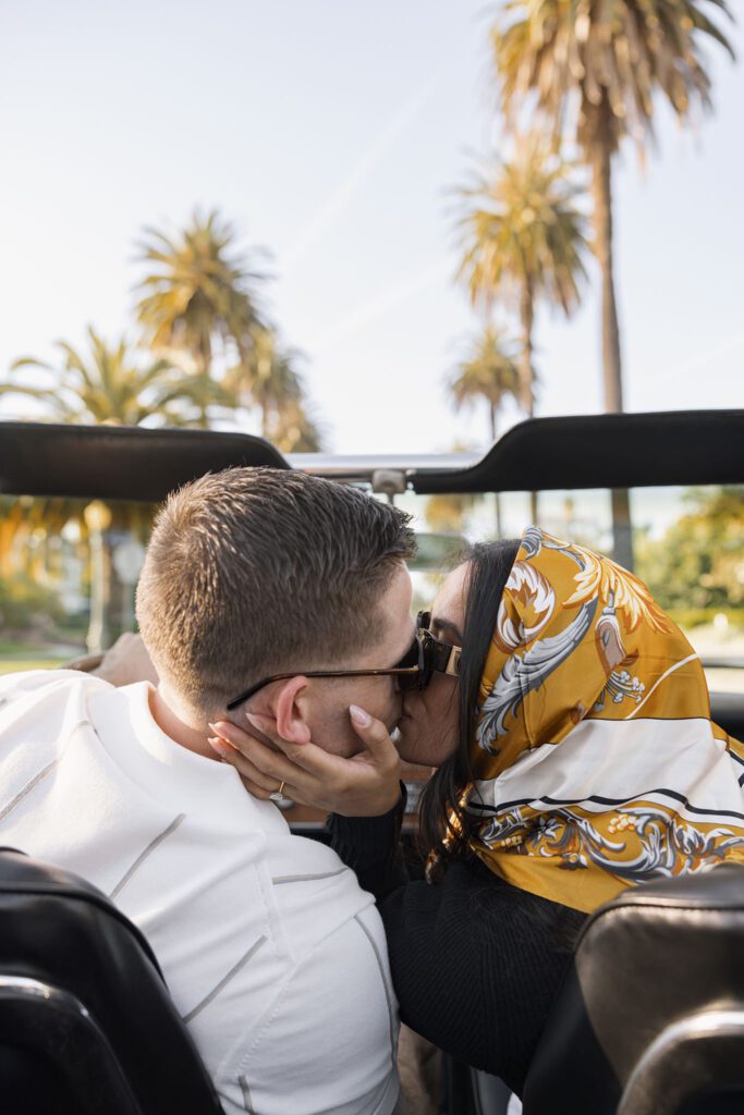 couple kissing in a convertible
